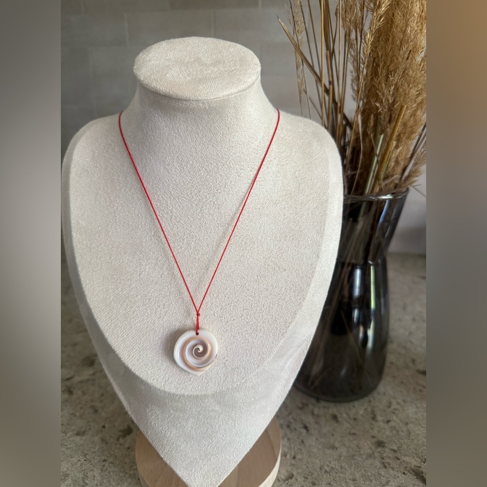 Elegant chakra pendant with red string